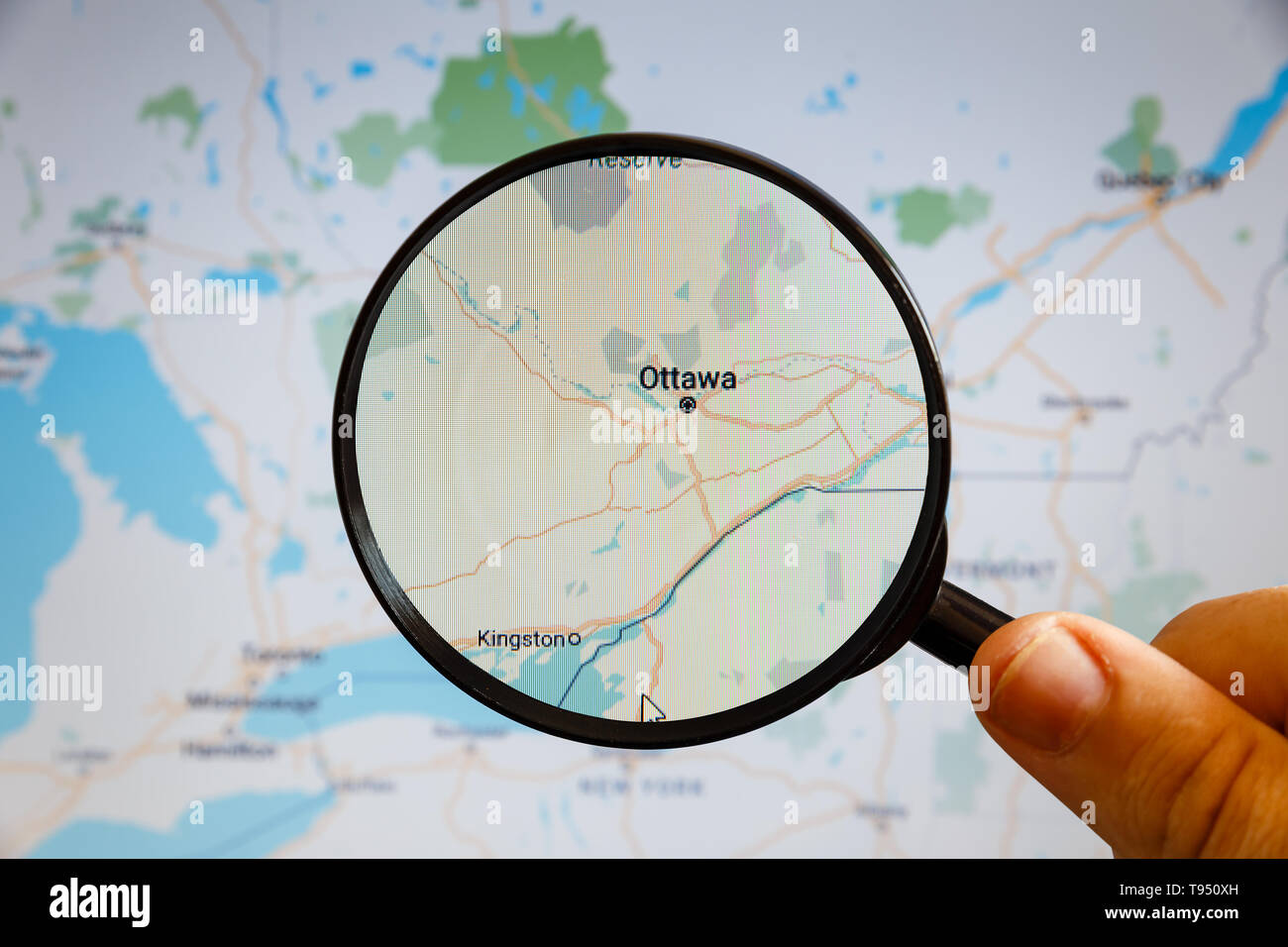 Ottawa, Canada. Political map. The city on the monitor screen through a magnifying glass in hand. Stock Photo