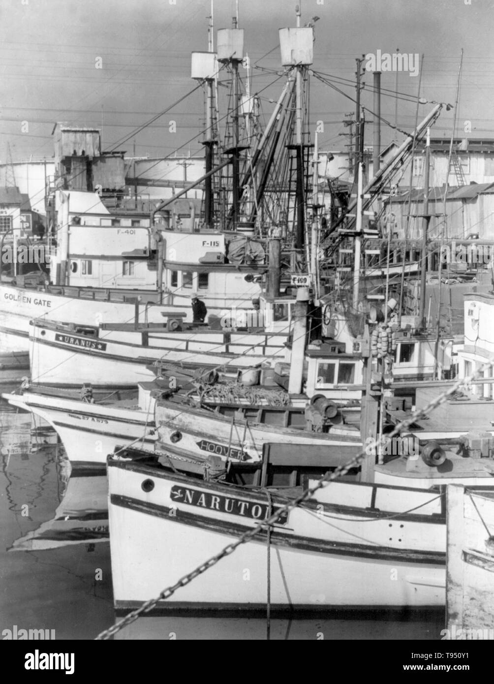Entitled: 'Part of fleet of fishing boats tied up at Terminal Island, owned by Japanese-Americans.' The internment of Japanese-Americans during WWII was the forced relocation and incarceration in camps of 110,000-120,000 people of Japanese ancestry (62% of the internees were US citizens) ordered by President Roosevelt shortly after Japan's attack on Pearl Harbor. Japanese-Americans were incarcerated based on local population concentrations and regional politics. Stock Photo