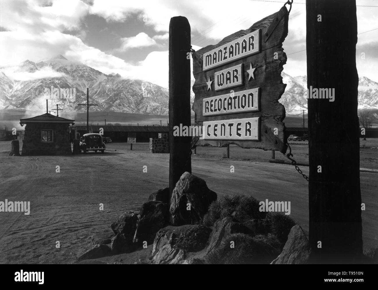 Entitled: 'Entrance to Manzanar, Manzanar Relocation Center.' The internment of Japanese-Americans during WWII was the forced relocation and incarceration in camps of 110,000-120,000 people of Japanese ancestry (62% of the internees were US citizens) ordered by President Roosevelt shortly after Japan's attack on Pearl Harbor. Japanese-Americans were incarcerated based on local population concentrations and regional politics. Stock Photo