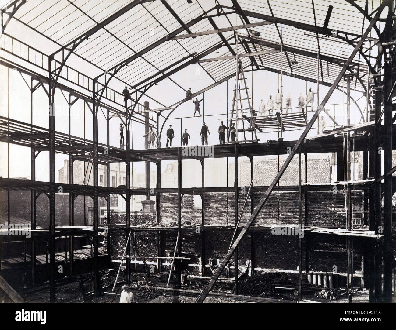 Construction site taken by French photographer Louis Lafon in the 1880s. The urbanization projects of nineteenth-century France called on photography to record all stages of construction. This building's framework integrated modern techniques of iron and steel-frame construction with traditional materials like brick masonry. Stock Photo