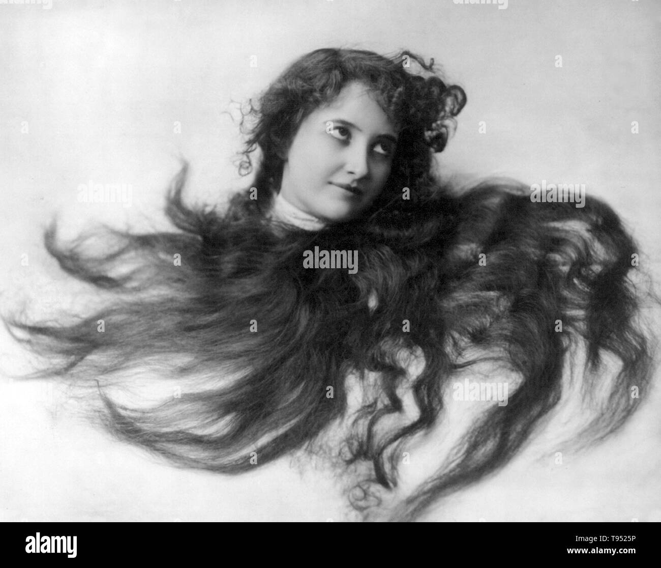 Entitled: 'Young woman modeling: Head, framed in flowing hair.' Photographed by Fitz W. Guerin, 1902. Stock Photo