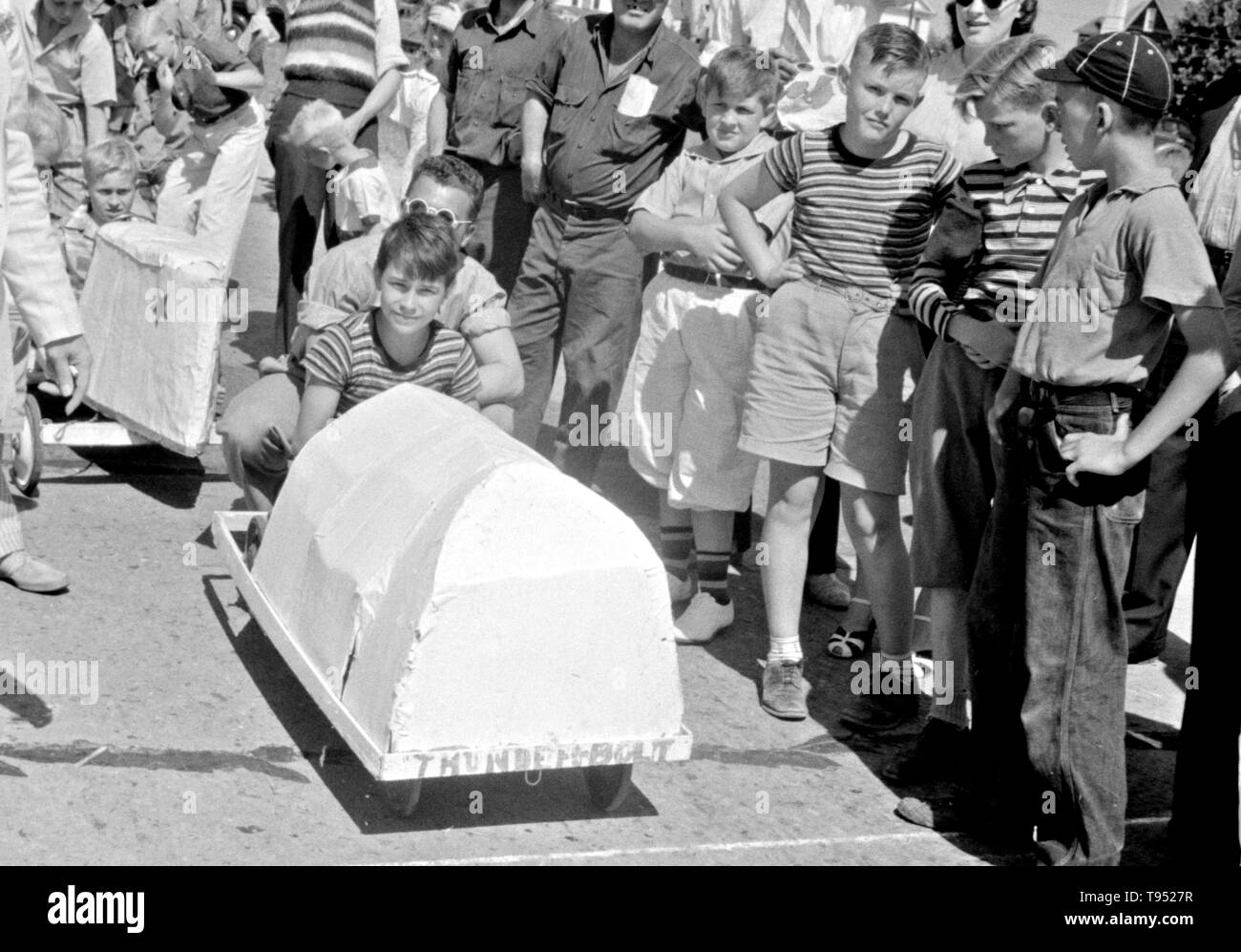 Entitled: 'Start of a soapbox auto race during July 4th celebration at Salisbury, Maryland.' The Soap Box is a youth soapbox car racing program which has been run in the United States since 1934. World Championship finals are held each July at Derby Downs in Akron, Ohio. Cars competing in this and related events are unpowered, relying completely upon gravity to move. Stock Photo