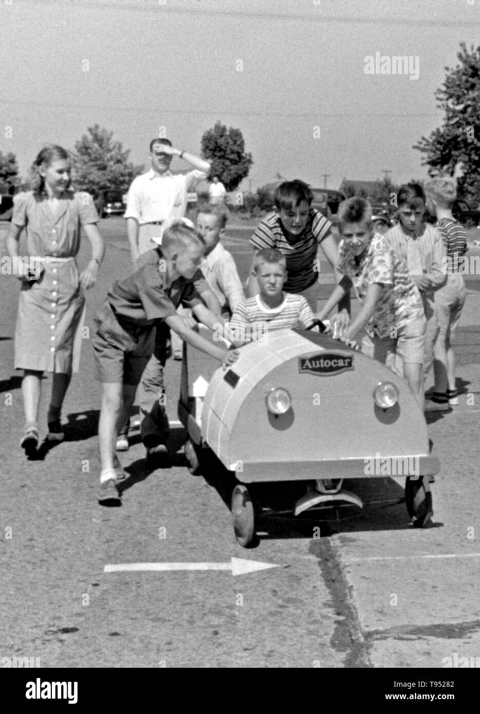 Entitled: 'Start of a soapbox auto race during July 4th celebration at Salisbury, Maryland.' The Soap Box is a youth soapbox car racing program which has been run in the United States since 1934. World Championship finals are held each July at Derby Downs in Akron, Ohio. Cars competing in this and related events are unpowered, relying completely upon gravity to move. Stock Photo