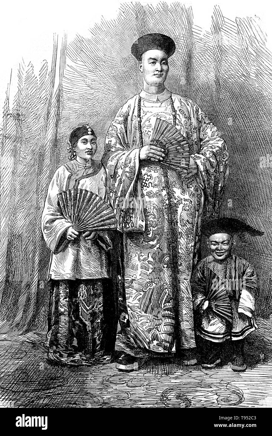 Chang Yu-sing the Chinese giant, with his wife, King-Foo and Chung Mow, a dwarf. Zhan Shichai AKA Chang Woo Gow (1841/47 - November 5, 1893) was a Chinese giant. His height was claimed to be over 8 feet, but there are no authoritative records. He left China in 1865 to travel to London where he appeared on stage, later travelling around Europe, and to the US and Australia as 'Chang the Chinese Giant'. Stock Photo