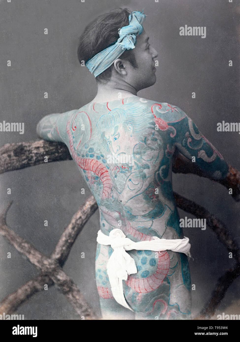 Japanese man with full-body tattoo, from c. 1870s - 1890s. Photographed by Kusakabe Kimbei (Japanese, 1841 - 1934, active 1880s - about 1912) or Baron Raimund von Stillfried (Austrian, 1839 - 1911). Hand-colored albumen silver print. Stock Photo