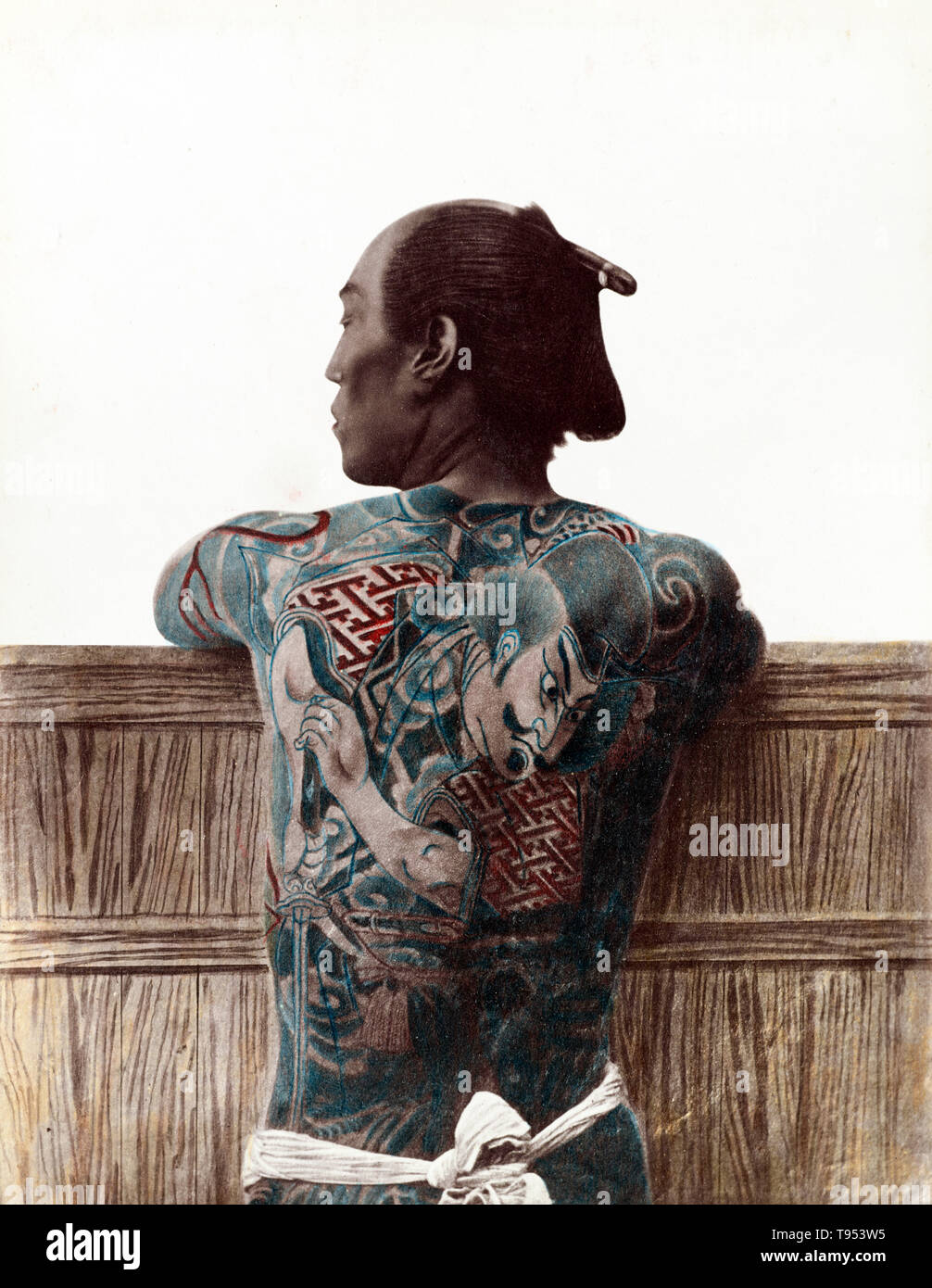 Japanese man with full-body tattoo, from c. 1870s - 1890s. Photographed by Kusakabe Kimbei (Japanese, 1841 - 1934, active 1880s - about 1912) or Baron Raimund von Stillfried (Austrian, 1839 - 1911). Hand-colored albumen silver print. Stock Photo