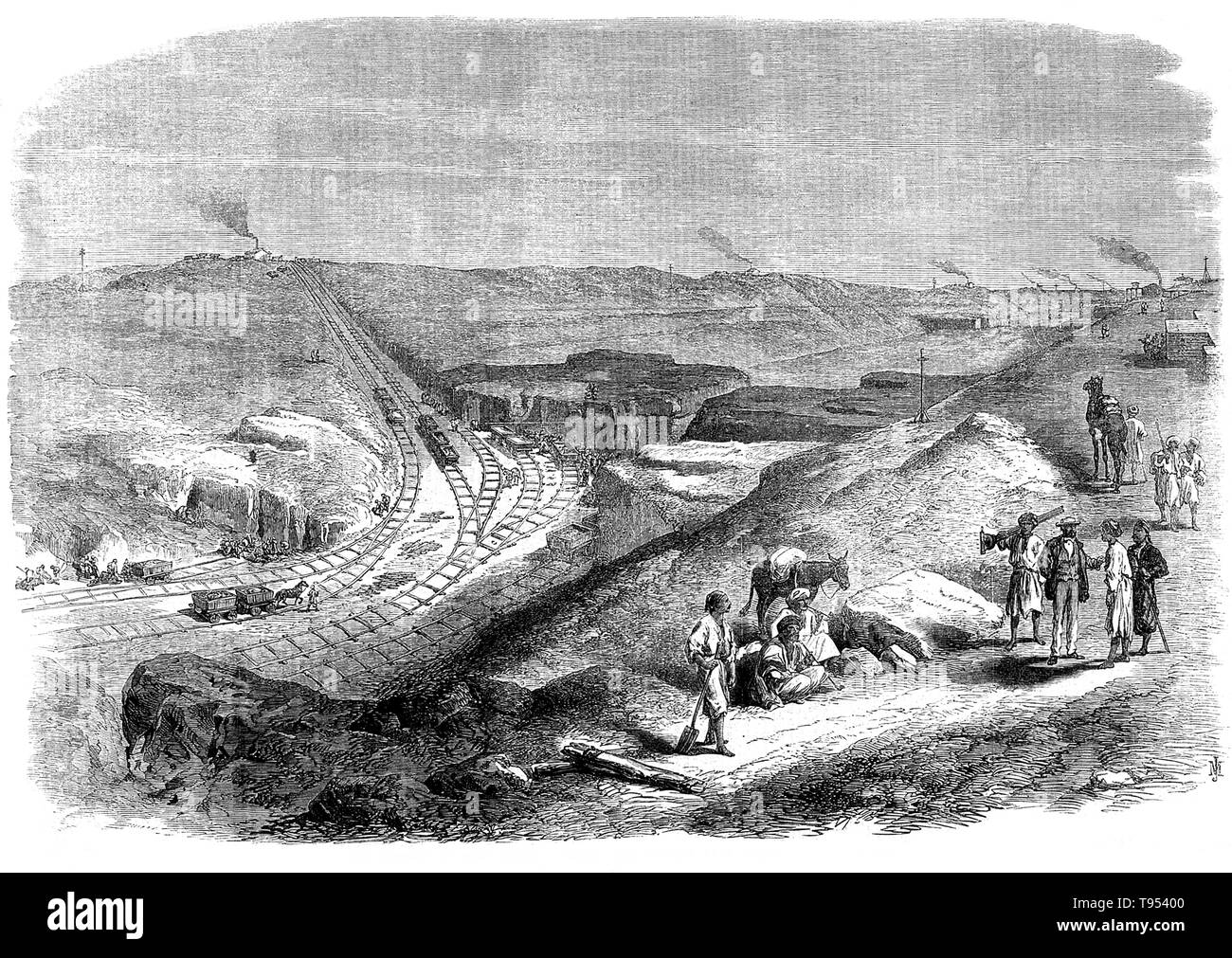 The Suez Canal is an artificial sea-level waterway in Egypt, connecting the Mediterranean Sea to the Red Sea through the Isthmus of Suez. Ferdinand de Lesseps obtained a concession from Sa'id Pasha, the Khedive of Egypt and Sudan, to create a company to construct a canal open to ships of all nations. The Suez Canal Company came into being in 1858 and work started on the shore of the future Port Said in April 1859. The excavation used forced labor of Egyptian workers during the first years. Stock Photo