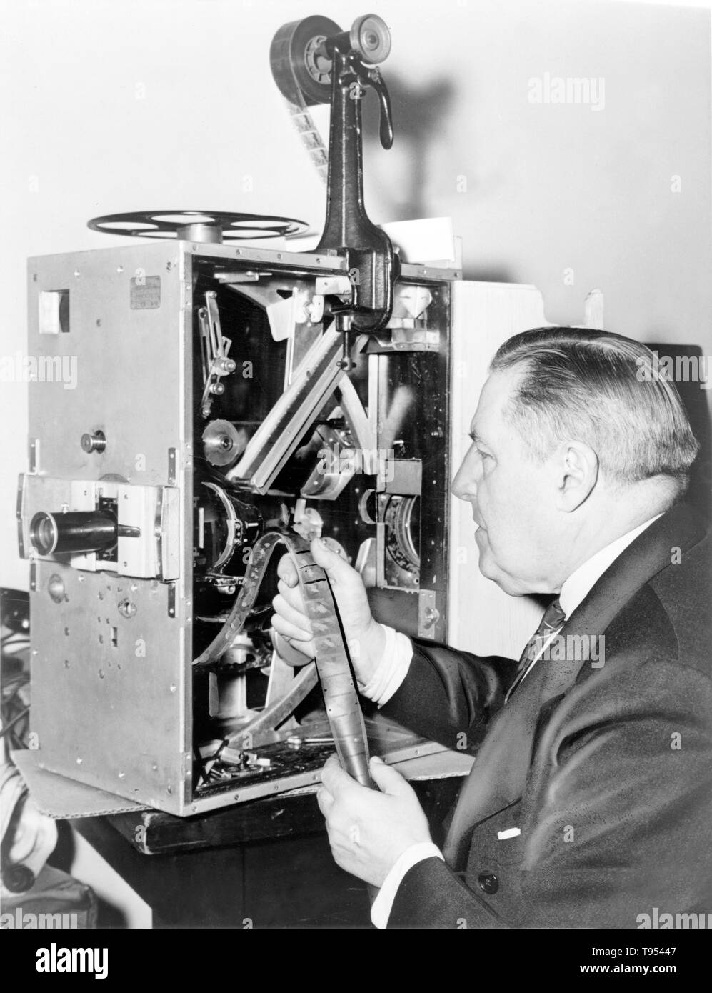 Billy Bitzer (1872-1944), American cinematographer, seated at a movie projector, photographed by Edward Lynch in the 1930s. Gottfried Wilhelm Billy Bitzer was a pioneering cinematographer notable for his close association with the writer, director and producer D. W. Griffith. Blitzer is known for innovations such as the fade out to close a movie scene, the iris shot, soft focus, artificial lighting and numerous other techniques. Stock Photo