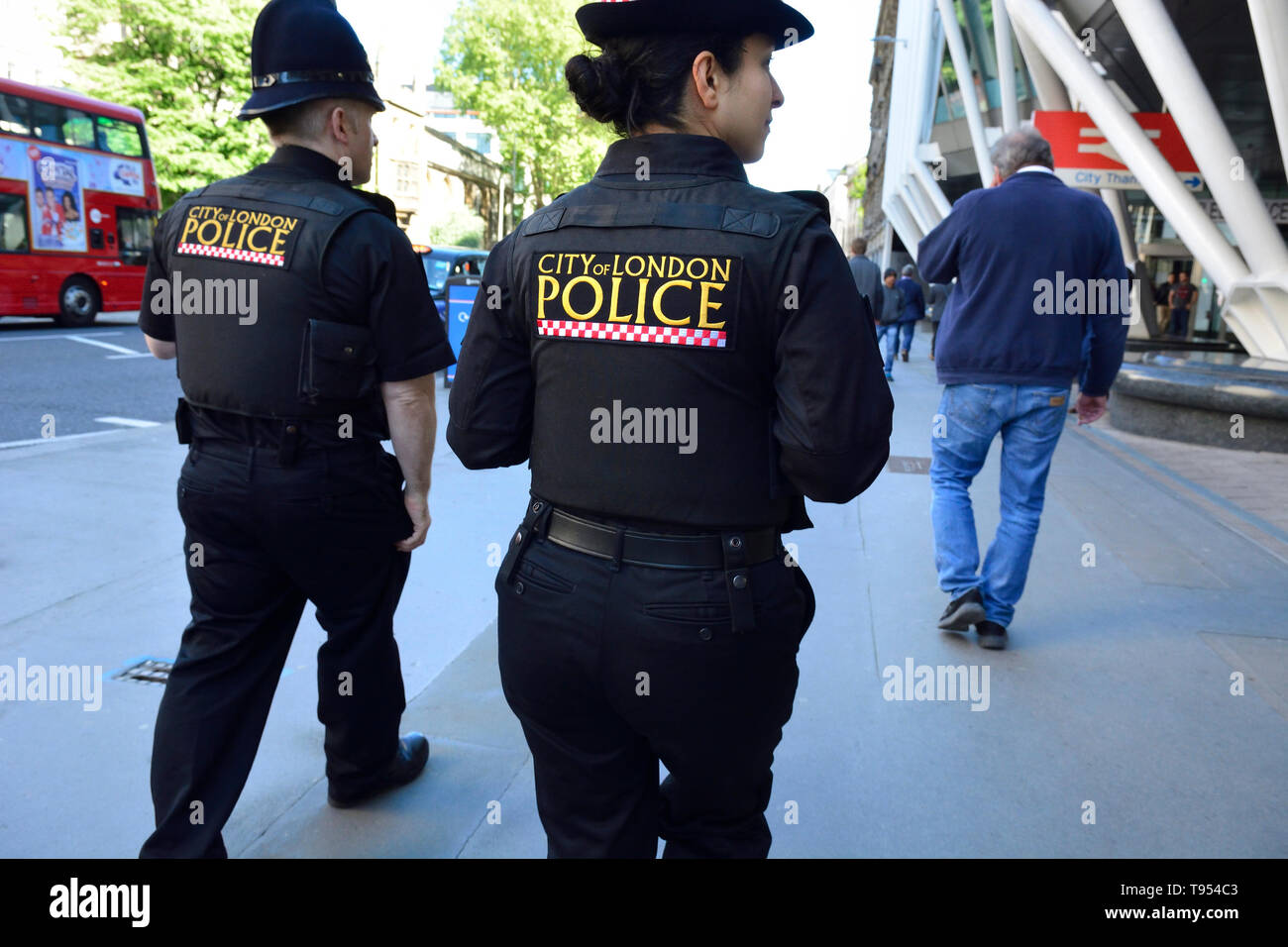 London, England, UK. Two City of London Police officers on patrol in Holborn - one male, one female Stock Photo