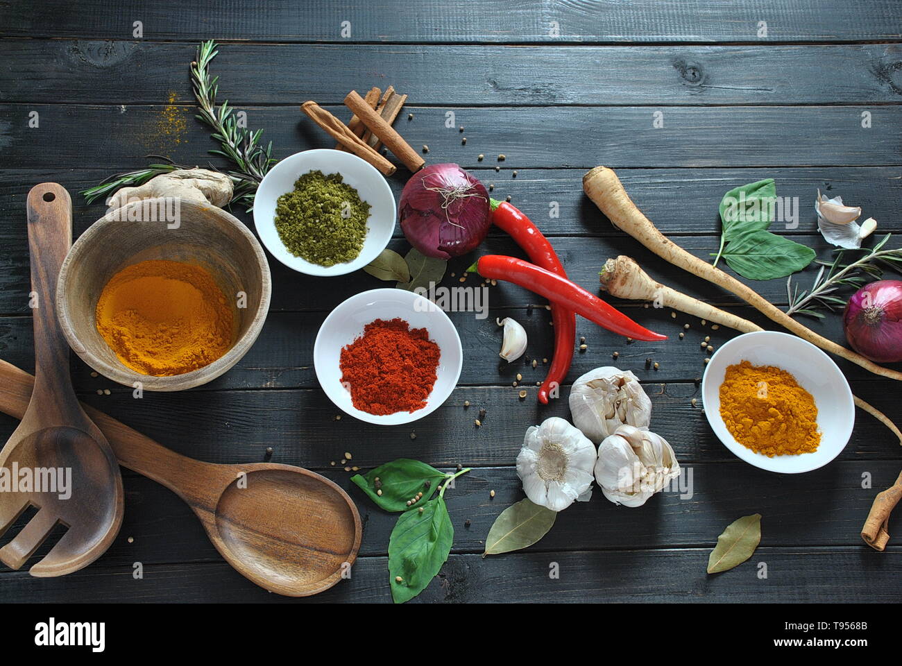 Colorful various of fresh and dried herbs, spices for cooking. Spice and herb seasoning, paprika powder, cinnamon, red onion. garlic, basil, ginger Stock Photo
