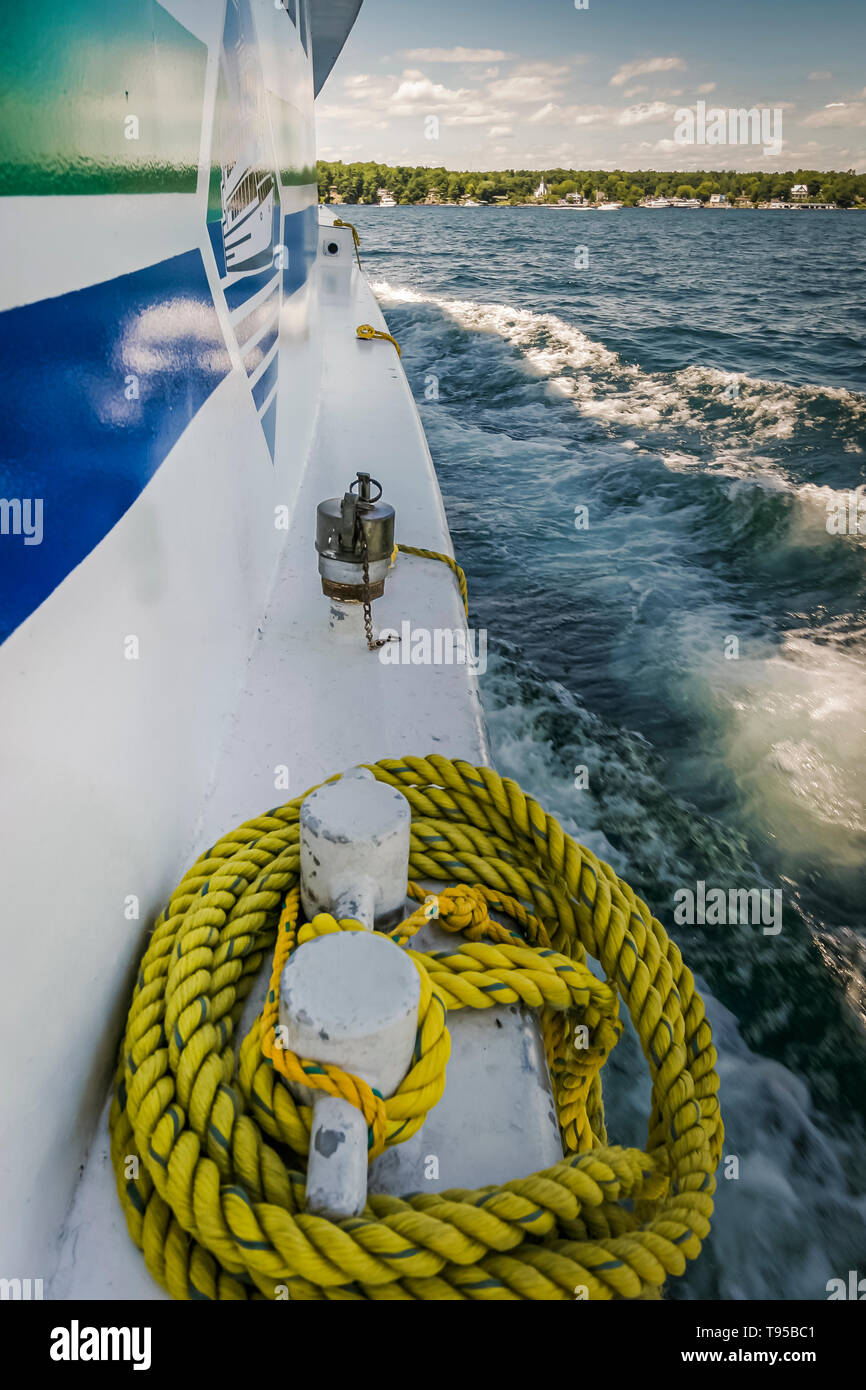 Anchor rope secured by the side of a cruise boat sailing Thousand Islands in Ontario, Canada