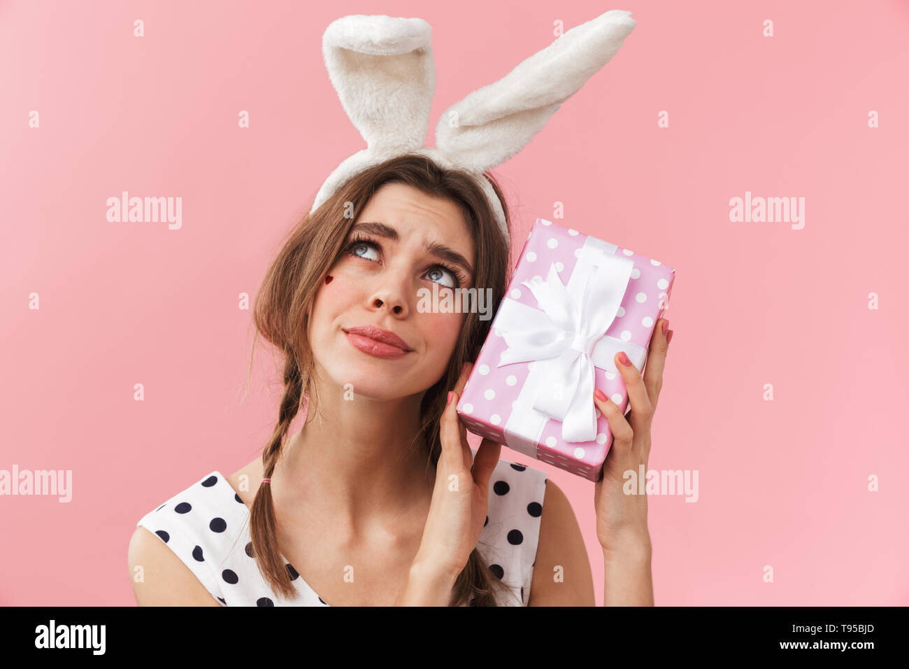 Portrait of a pretty lovely girl wearing bunny ears standing isolated