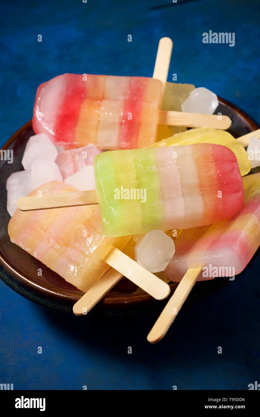 Popsicles on a blue table. Stock Photo