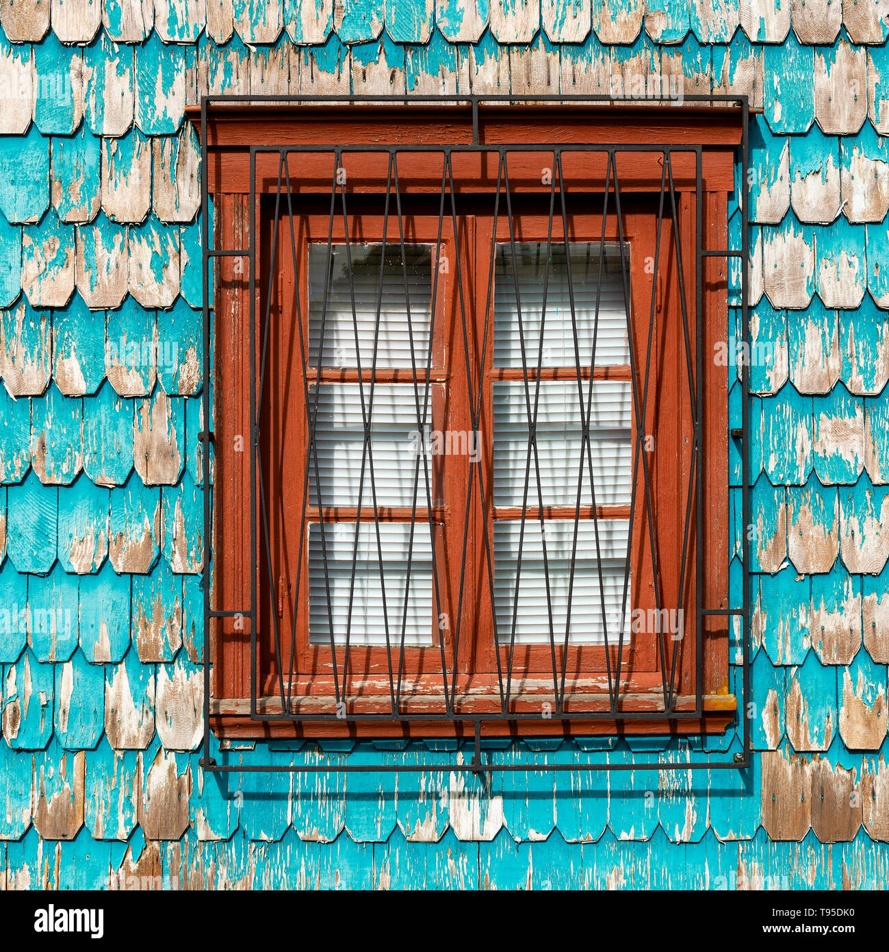 Square architecture of turquoise larch wood paneling facade with window in Puerto Varas, traditional in the chilean lake district and Patagonia, Chile. Stock Photo