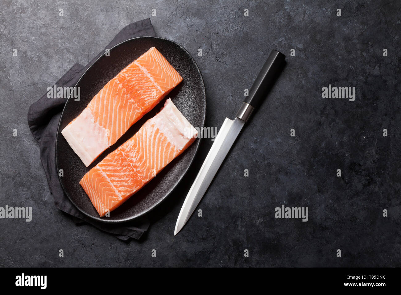 Raw salmon fish fillet for cooking on stone table. Top view flat lay ...