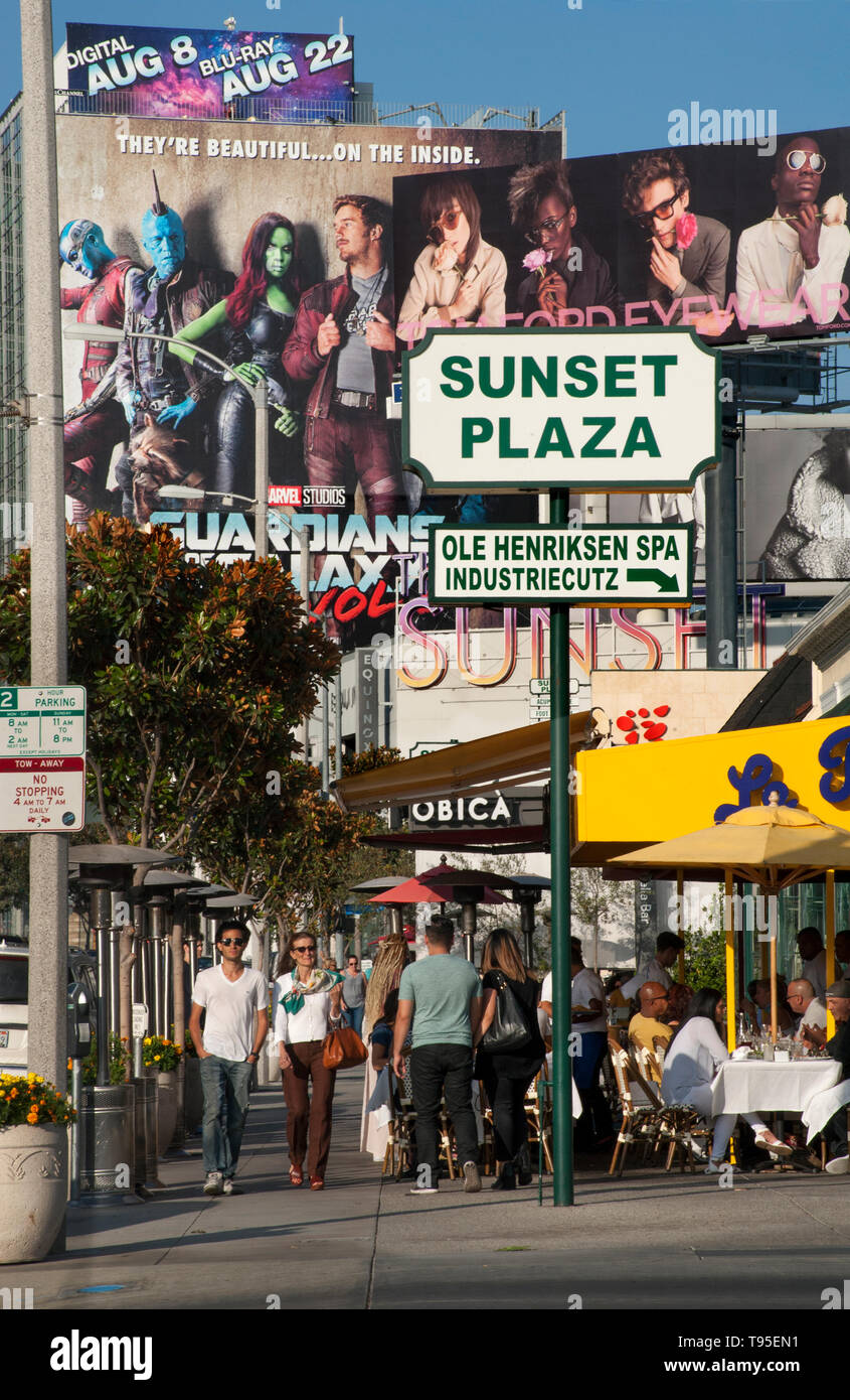 Sidewalk cafes and giant billboards at the sunset Plaza area of the