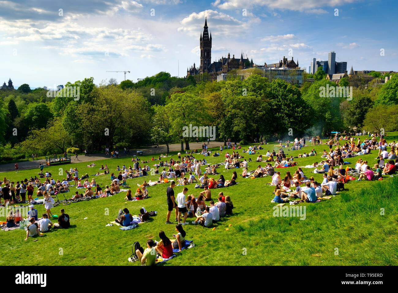 Hot weather and people in Glasgow Kelvingrove Park with Glasgow