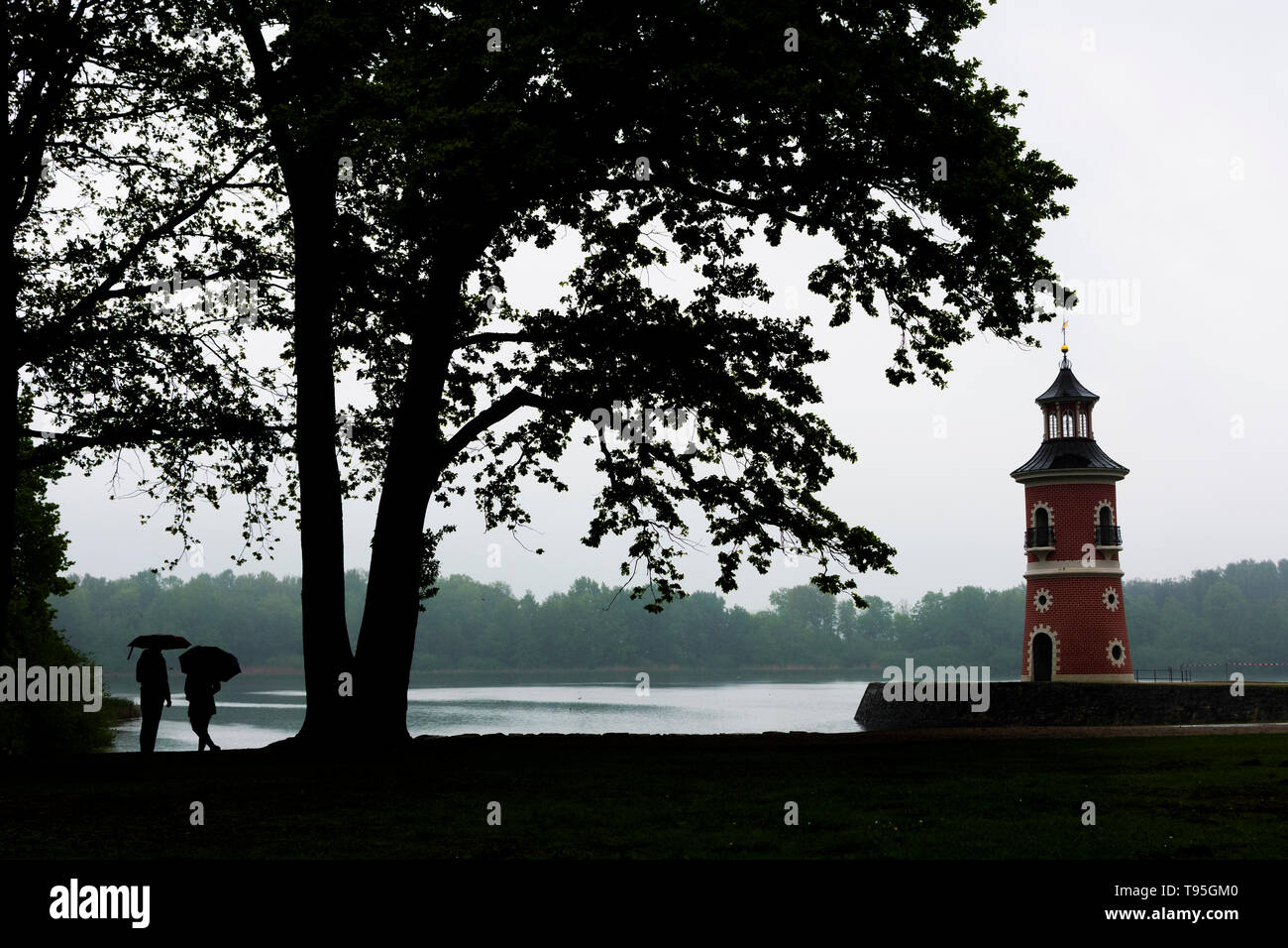 Moritzburg: Lighthouse with jetty at pond Großteich, rain, people with umbrella in , Sachsen, Saxony, Germany Stock Photo