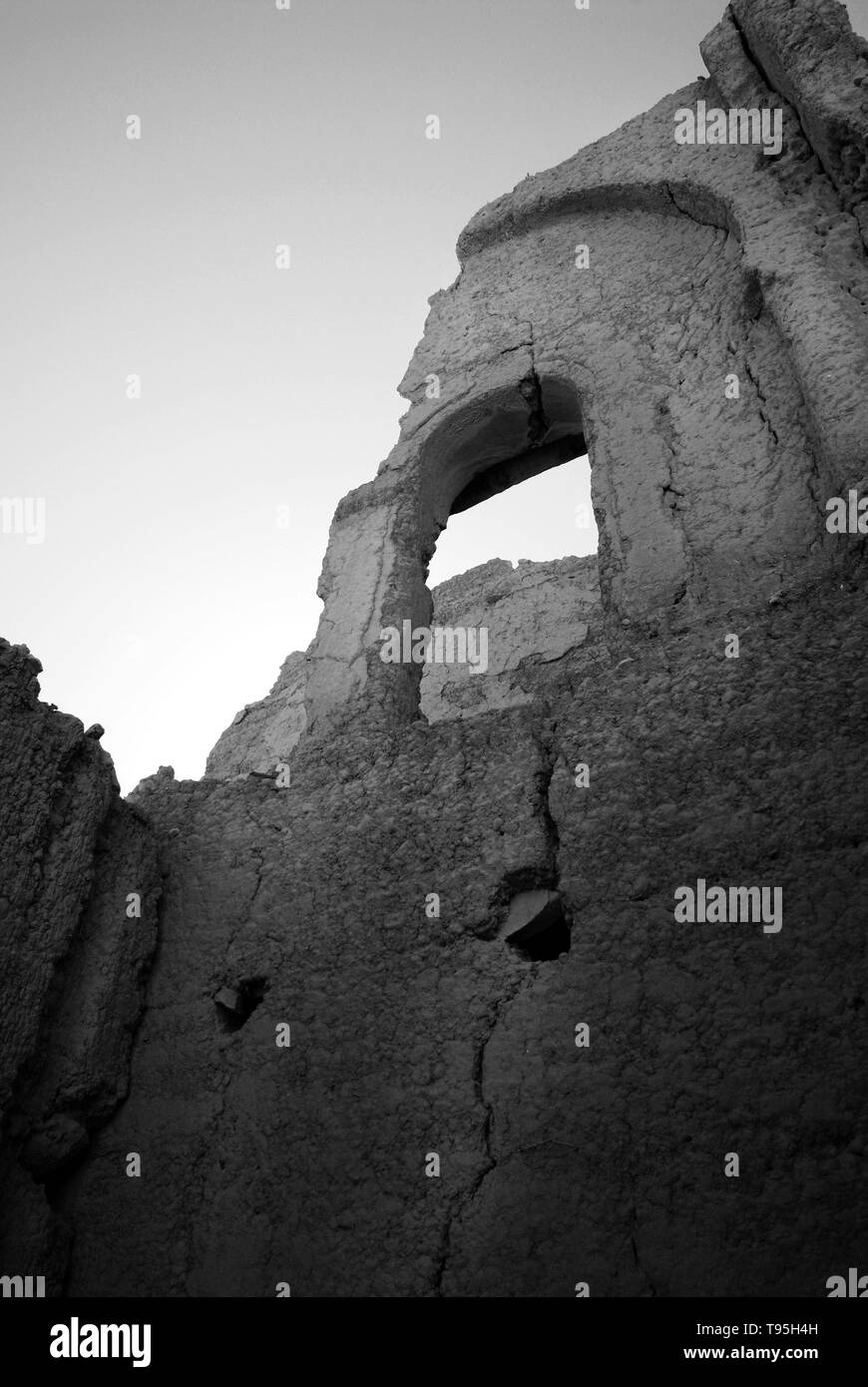 A ruined Kasbah in Morocco, traditional fortress in greyscale. Stock Photo