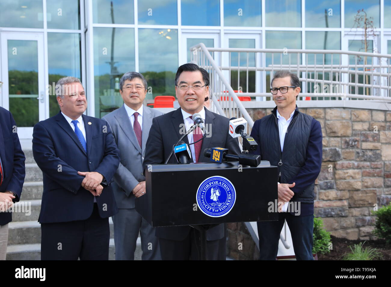 (190516) -- NEW YORK, May 16, 2019 (Xinhua) -- Huang Ping (C), Chinese Consul General in New York, gives a speech during a ribbon-cutting ceremony in the city of Yonkers, in the U.S. state of New York, on May 15, 2019. A China-invested residential building officially opened on Wednesday in the city of Yonkers, in the U.S. state of New York. The River Club at Hudson Park, a 214-unit luxury apartment building, is a public-private partnership project developed by China Construction America (CCA) since 2015. It helped complete the three-phased Hudson Park development plan that was started more tha Stock Photo