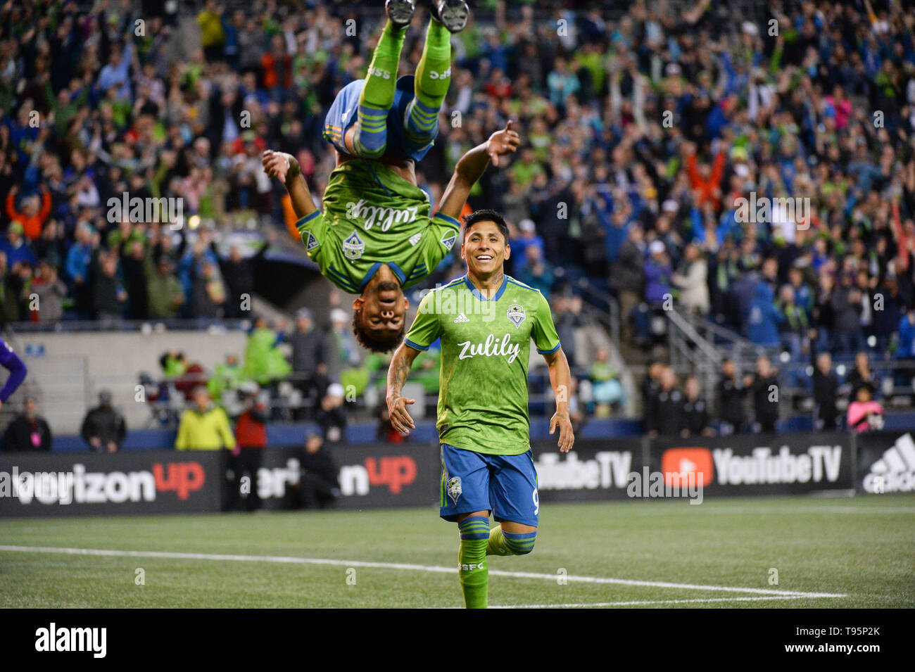 Seattle, Washington, USA. 15th May, 2019. The Sounders Raul Ruidiaz (9) looks on as Bwana (70) celebrates his goal with a flip. Orlando City visited the Seattle Sounders for an MLS match at Century Link Field in Seattle, WA. Seattle won the match 2-1. Credit: Jeff Halstead/ZUMA Wire/Alamy Live News Stock Photo