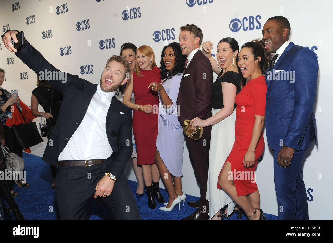 New York, NY, USA. 15th May, 2019. Kellan Lutz photo bombs Lindsay Mendez, Marg Helgenberger, Simone Missick, Wilson Bethel, Ruthie Ann Miles, Jessica Camacho and J Alex Brinson from ALL RISE attends the 2019 CBS Upfront presentation at the Plaza on May 15, 2019 in New York City. Credit: John Palmer/Media Punch/Alamy Live News Stock Photo