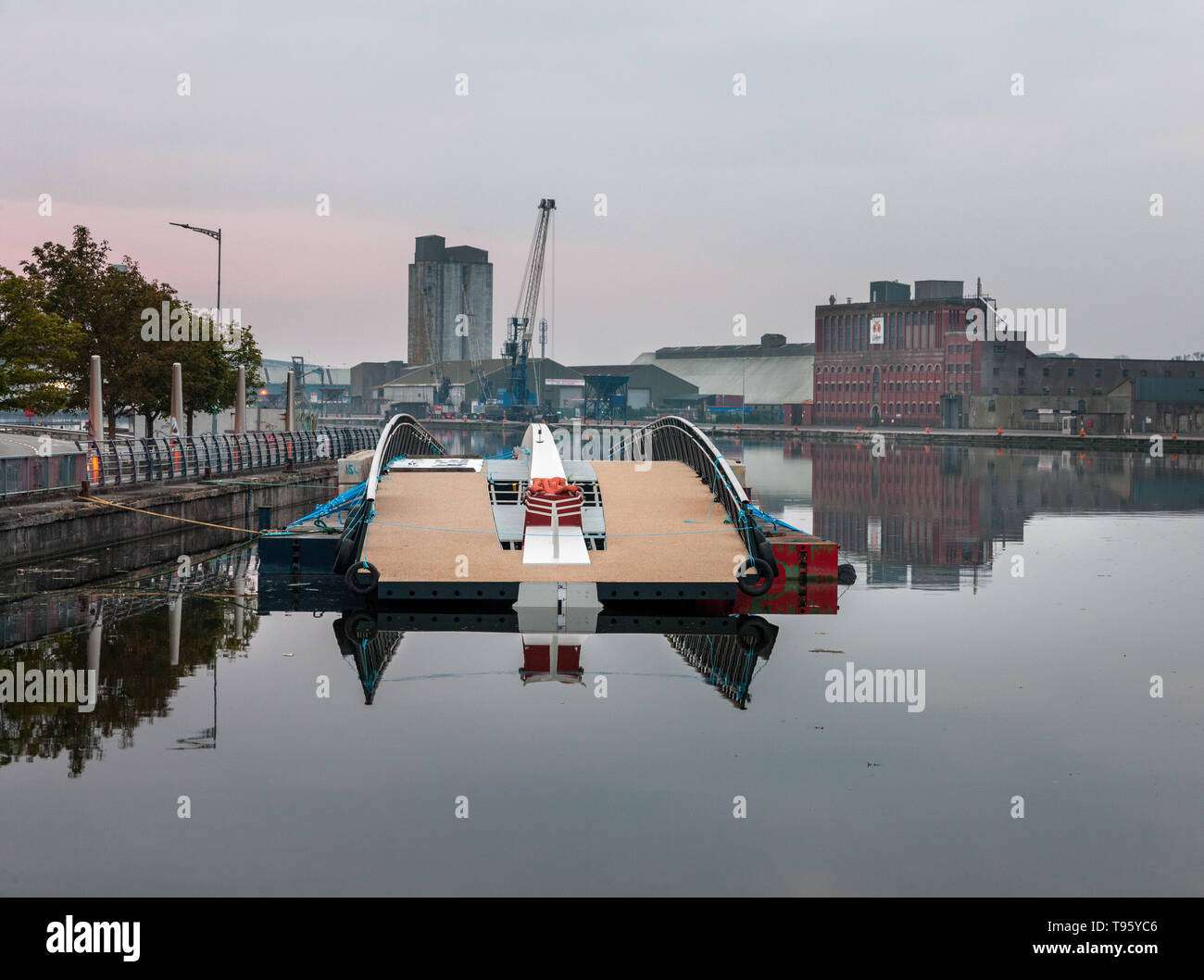 Cork City, Cork, Ireland. 17th May, 2019. The new Mary Elmes Bridge moored overnight at Penrose Quay awaitng a low tide so it can be taken upstream and lowered by crane in position connecting Patrick's and Merchants Quay's in Cork City, Ireland. Credit: David Creedon/Alamy Live News Stock Photo