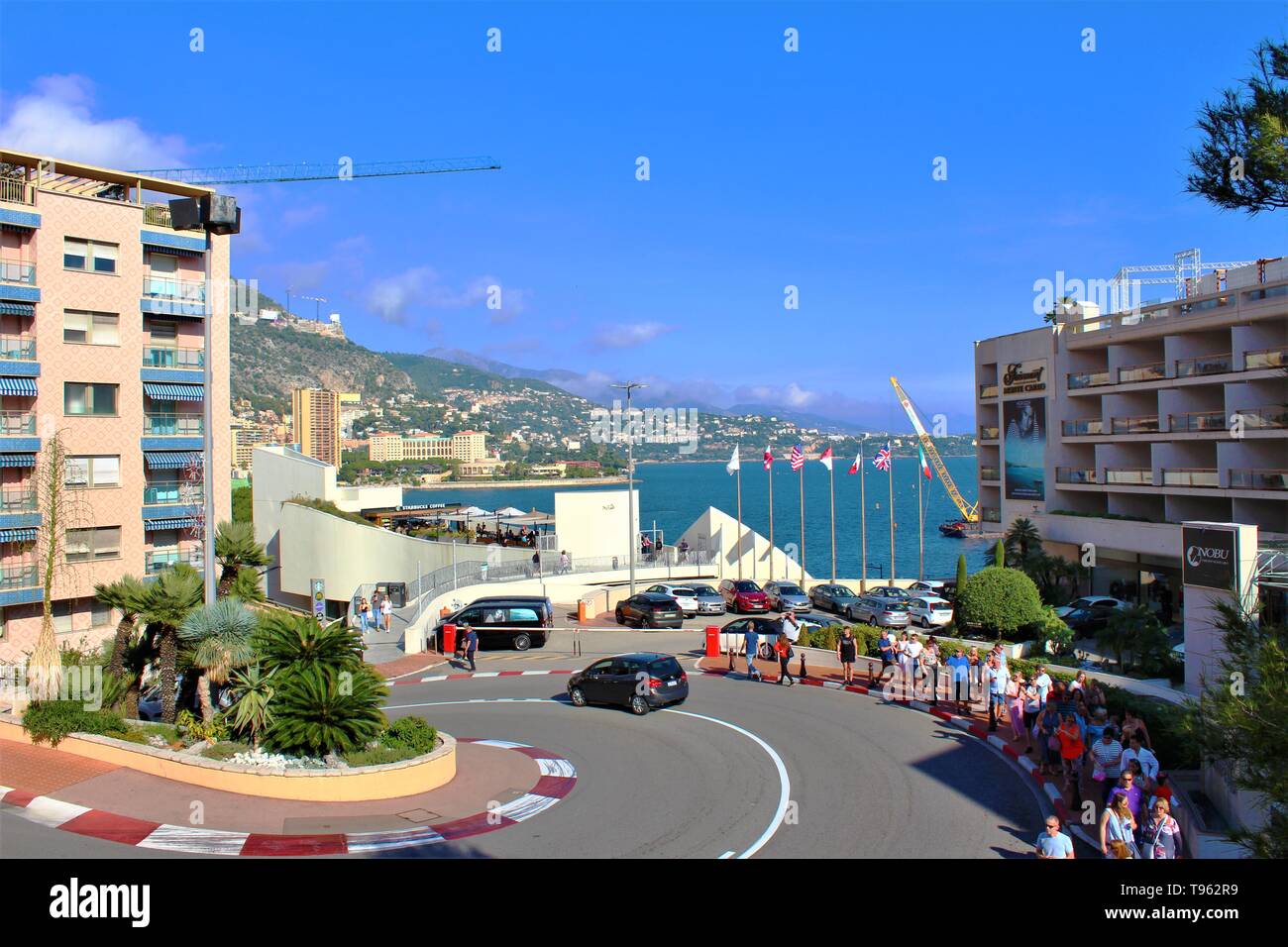 Tourists taking in the famous 'Fairmont Hairpin' chicane bend of the Monaco Grand Prix circuit, opposite the Fairmont Hotel in Monte Carlo. Stock Photo