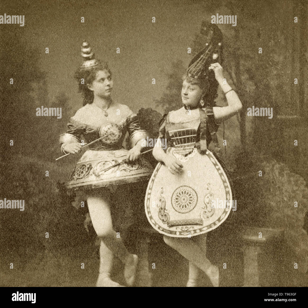 Women dressed in instrument costumes, c. 1865. Albumen silver print. Stock Photo