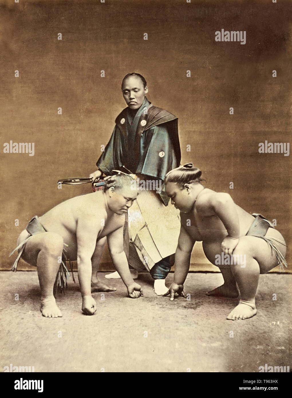 Sumo wrestlers. Kusakabe Kimbei (Japanese, 1841 - 1934). Taken c. 1870s - 1890s. Hand-colored albumen silver print. Professional sumo roots trace back to the 1600s in Japan. The original wrestlers were probably samurai without masters, who needed to find an alternative form of income. Current professional sumo tournaments began in the Tomioka Hachiman Shrine in 1684. Stock Photo