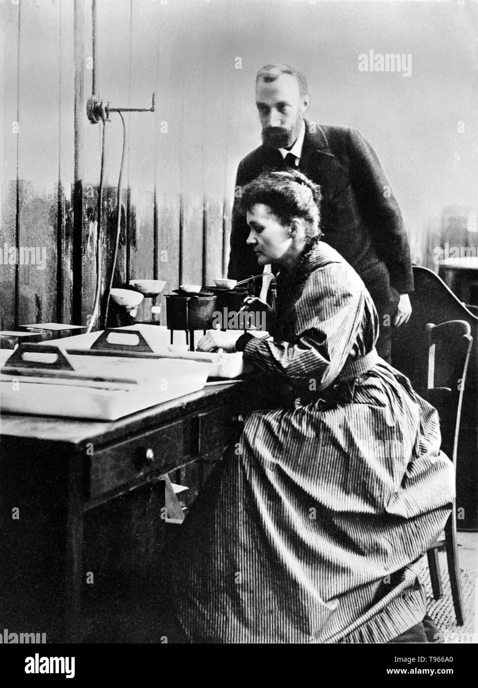 Marie and Pierre Curie in their laboratory in Paris. Pierre Curie was introduced to Maria Sklodowska by a friend and took Maria into his laboratory as his student. He began to regard her as his muse. She refused his initial proposal, but finally agreed to marry him on July 26, 1895. Marie Curie (November 7, 1867 - July 4, 1934) was a Polish-French physicist and chemist. Stock Photo