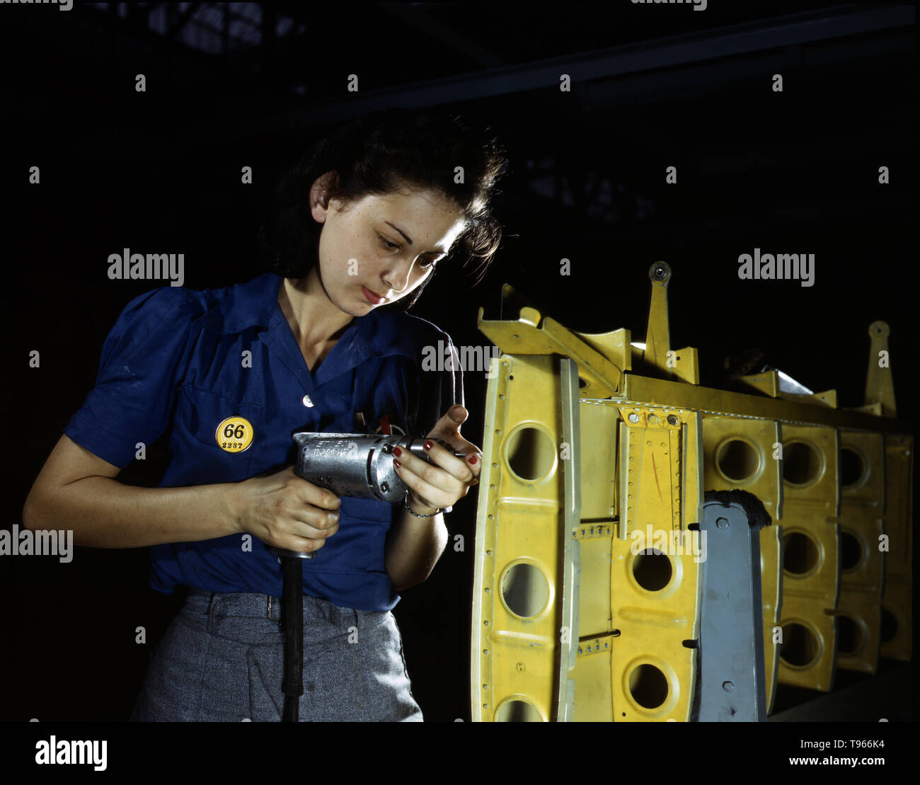Drilling horizontal stabilizers: operating a hand drill, this woman worker at Vultee-Nashville is shown working on the horizontal stabilizer for a Vultee Vengeance dive bomber, Tennessee. The Vengeance (A-31) was originally designed for the French.  Although the image of 'Rosie the Riveter' reflected the industrial work of welders and riveters, the majority of working women filled non-factory positions in every sector of the economy. Photographed by Alfred T. Palmer, 1943. Stock Photo