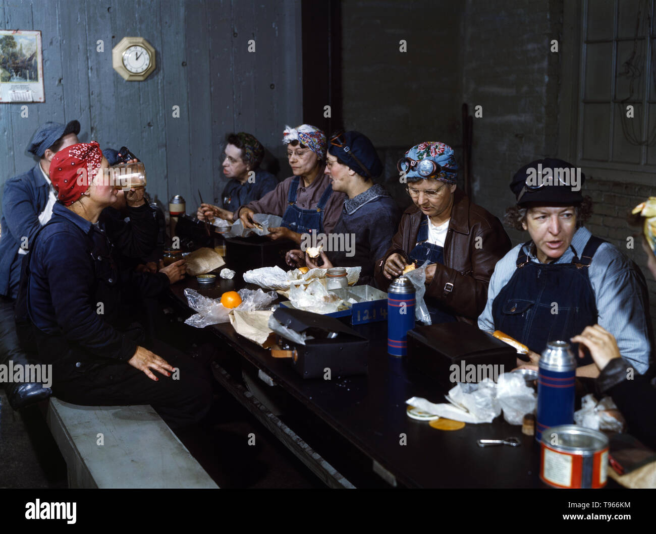 Women workers employed as wipers in the roundhouse having lunch in their rest room, C. & N.W. R.R., Clinton, Iowa. Although the image of 'Rosie the Riveter' reflected the industrial work of welders and riveters, the majority of working women filled non-factory positions in every sector of the economy. What unified the experiences of these women was that they proved to themselves, and the country, that they could do a man's job and could do it well. Photographed by Jack Delano, 1943. Stock Photo