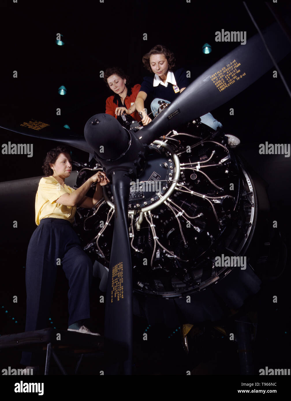 Women at work on C-47 Douglas cargo transport, Douglas Aircraft Company, Long Beach, California. Although the image of 'Rosie the Riveter' reflected the industrial work of welders and riveters, the majority of working women filled non-factory positions in every sector of the economy. What unified the experiences of these women was that they proved to themselves, and the country, that they could do a man's job and could do it well. Photographed by Alfred T. Palmer, 1942. Stock Photo