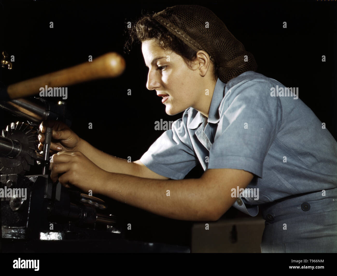 Mary Louise Stepan, 21, used to be a waitress. She has a brother in the air corps. She is working on transport parts in the hand mill, Consolidated Aircraft Corp., Fort Worth, Texas. Although the image of 'Rosie the Riveter' reflected the industrial work of welders and riveters, the majority of working women filled non-factory positions in every sector of the economy. What unified the experiences of these women was that they proved to themselves, and the country, that they could do a man's job and could do it well. Photographed by Howard R. Hollem, 1942. Stock Photo