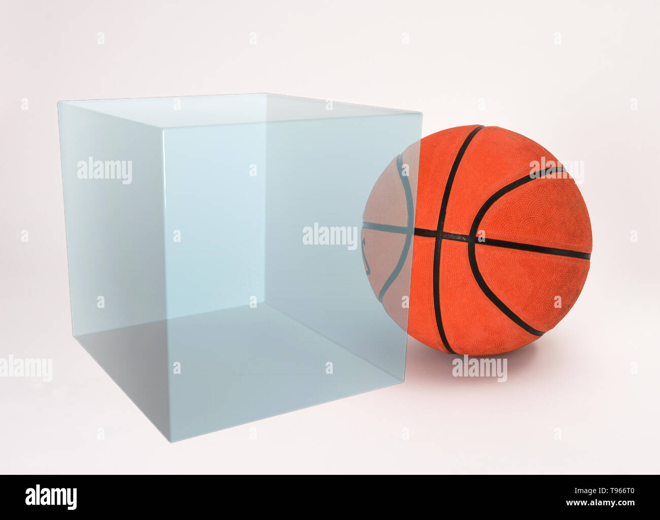 The box contains 1 mole of gas; the molar volume of an ideal gas is 22.4 L at 0°C and 1 atm of pressure. A basketball fits loosely into a box having this volume. Stock Photo