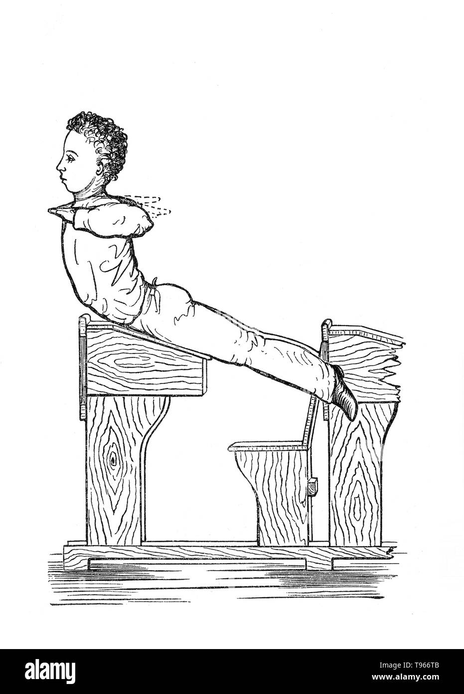 Schoolchild doing gymnastics at their desk. Gymnastics is a sport practiced by men and women that requires balance, strength, flexibility, agility, coordination, endurance and control. The movements involved in gymnastics contribute to the development of the arms, legs, shoulders, back, chest and abdominal muscle groups. Alertness, precision, daring, self-confidence and self-discipline are mental traits that can also be developed through gymnastics. Stock Photo