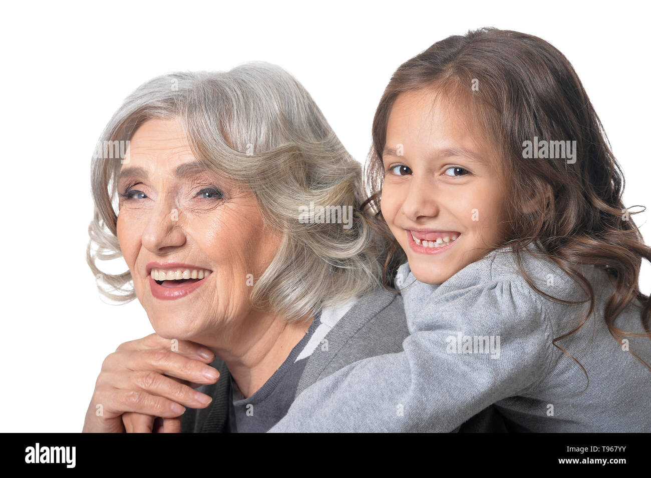 Grandmother Hugging With Her Cute Granddaughter Isolated On White