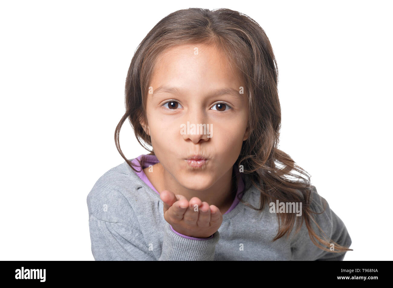 Beautiful young child blowing kiss hires stock photography and images