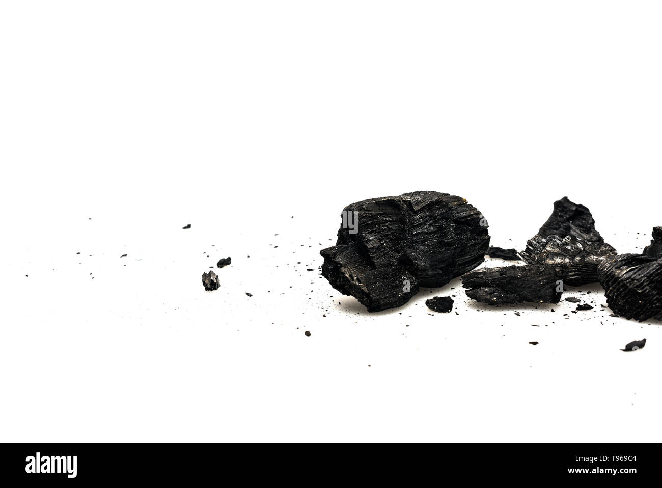 Black burnt firewood with ash on white surface Stock Photo - Alamy