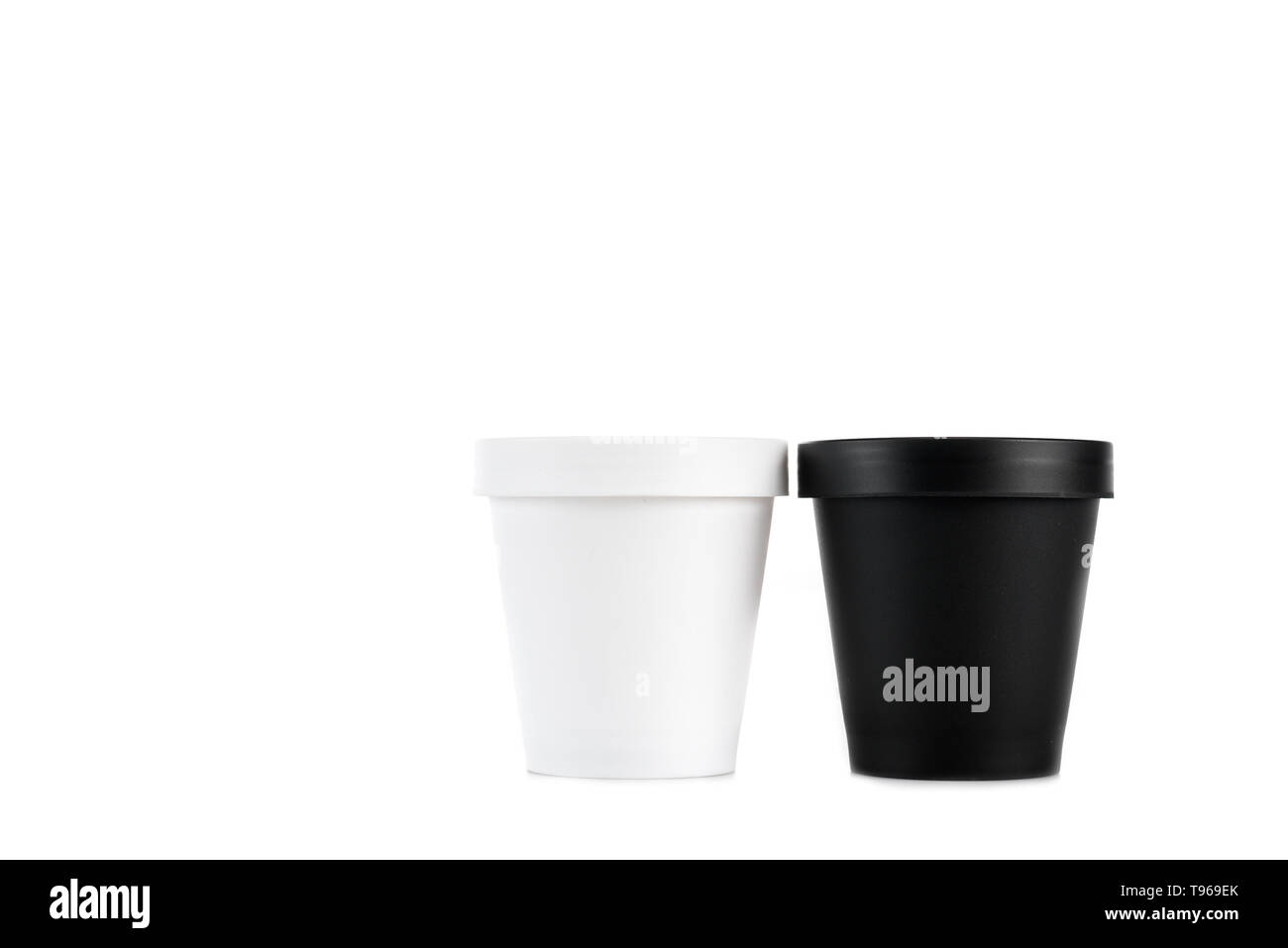 White and black plastic cups isolated on white Stock Photo