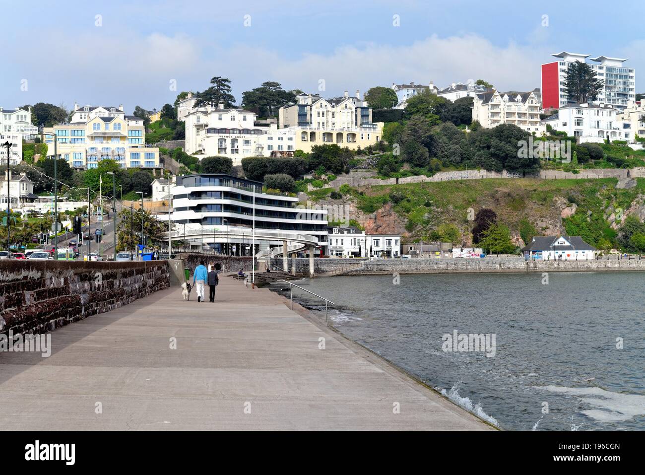 The esplanade on Torquay seafront with small hotels on hillside, Devon England UK Stock Photo