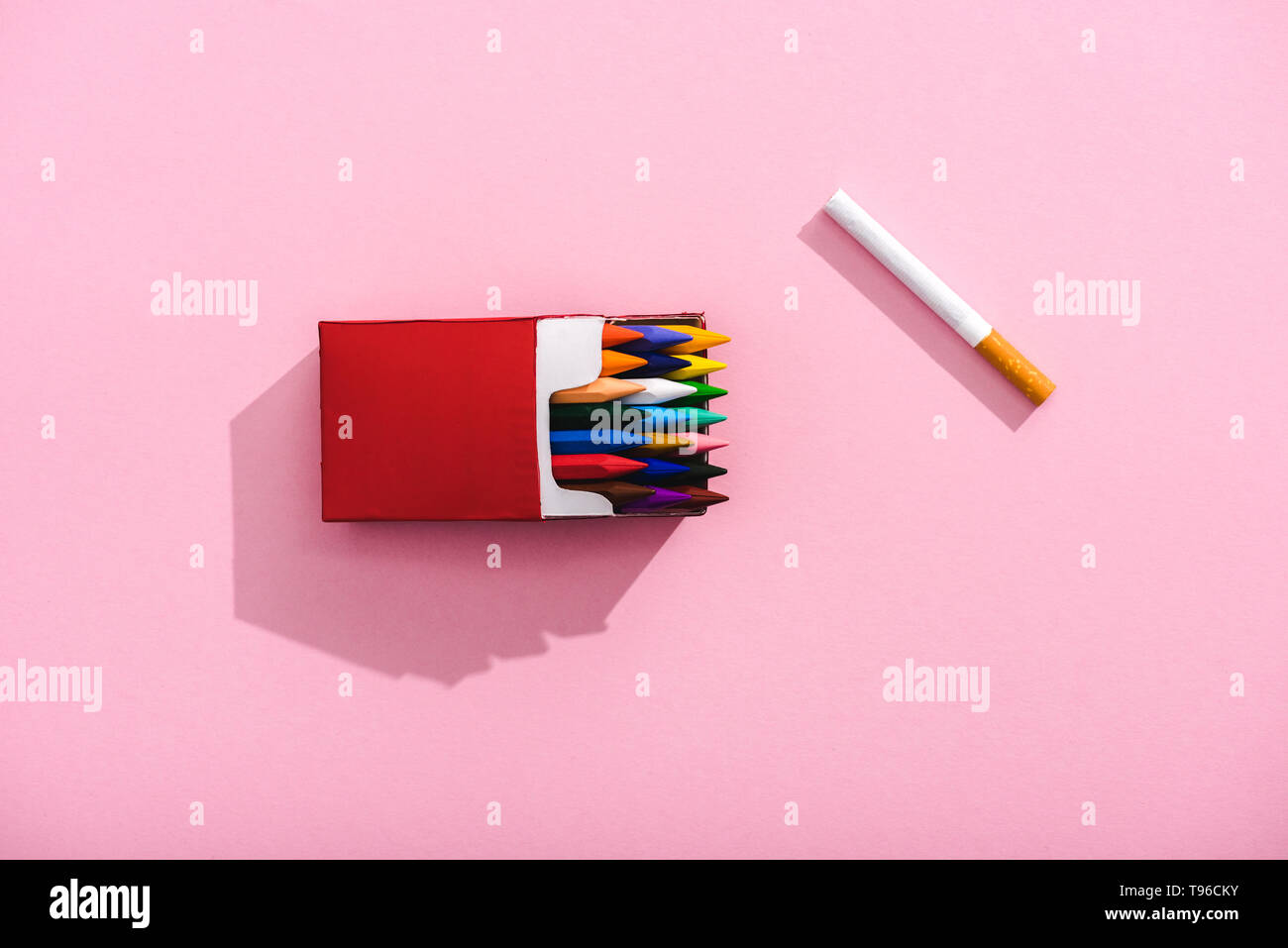 top view of colorful crayons in cigarette pack and tobacco cigarette on  pink, smoking concept Stock Photo - Alamy