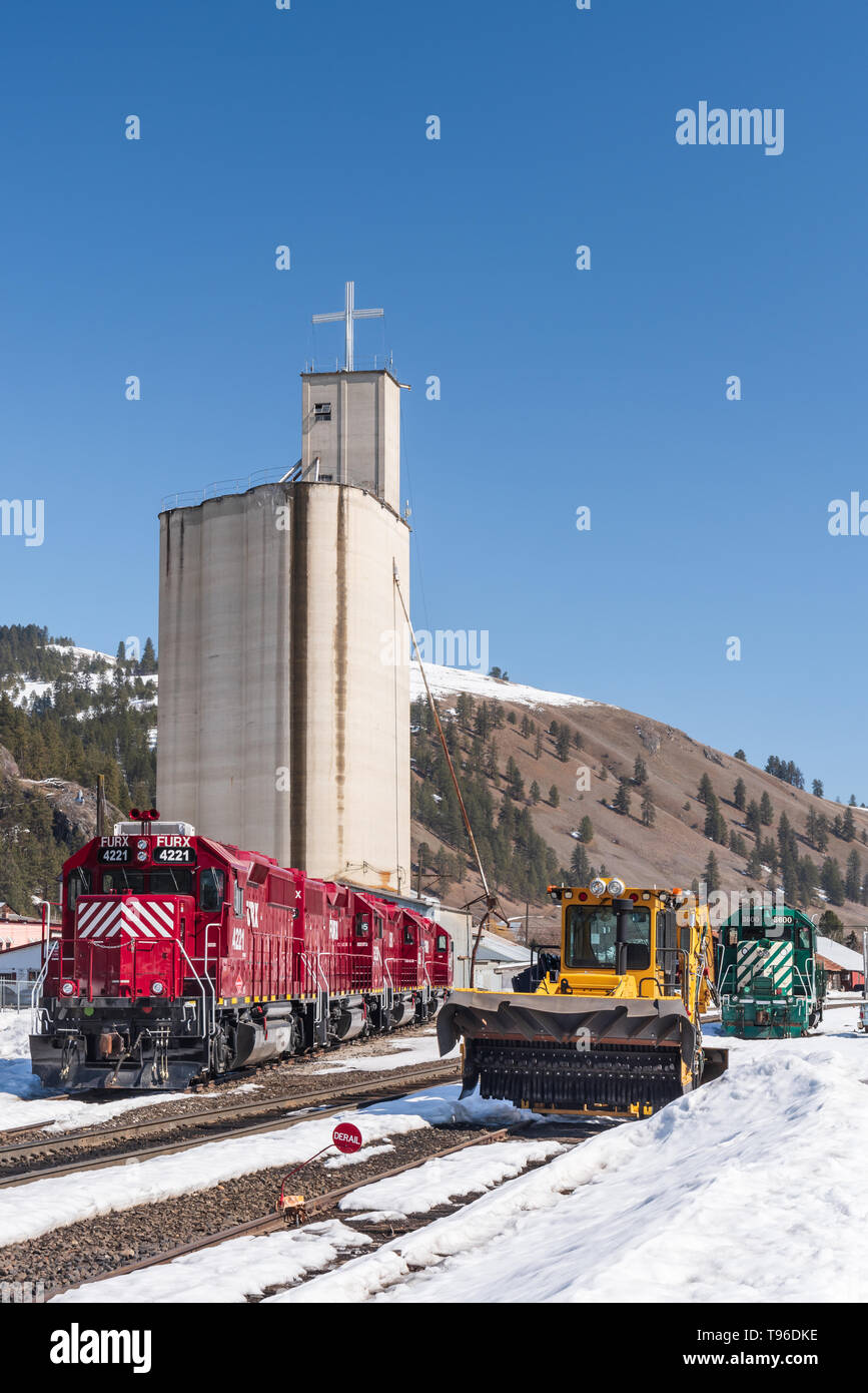The grain elevator with a cross in Kettle Falls Washington during a sunny early spring day with