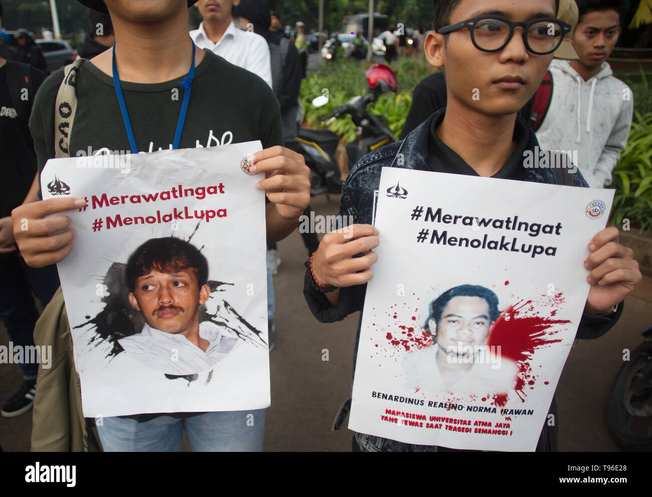 Demonstrators seen with posters of Munir and Benardinus Irawan victims of human rights violations during the protest. The Victim Solidarity Network for Justice (JSKK) held a silent protest in front of the Presidential Palace in Jakarta. The act is commonly known as Aksi Kamisan and this was its 586th day and the demand is for the President to resolve human rights violations in the May 1998 Tragedy: Trisakti - Semanggi I - Semanggi II and May 13-15 1998 Riots. Stock Photo