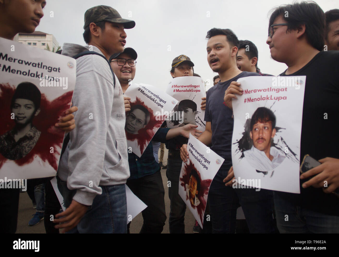 Demonstrators seen with posters of Munir and Benardinus Irawan victims of human rights violations during the protest. The Victim Solidarity Network for Justice (JSKK) held a silent protest in front of the Presidential Palace in Jakarta. The act is commonly known as Aksi Kamisan and this was its 586th day and the demand is for the President to resolve human rights violations in the May 1998 Tragedy: Trisakti - Semanggi I - Semanggi II and May 13-15 1998 Riots. Stock Photo