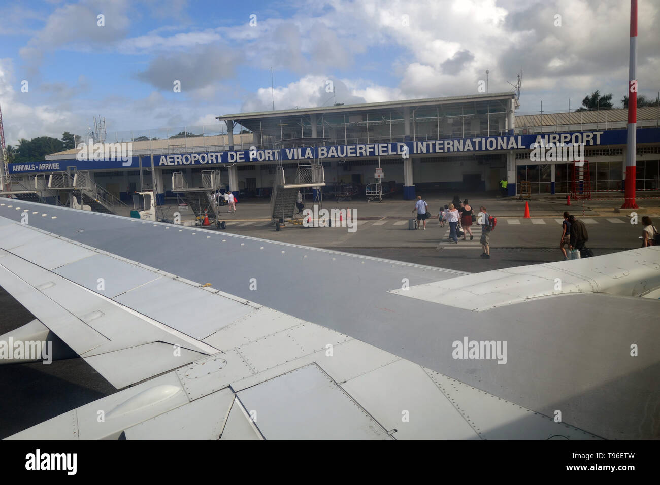 People disembarking plane arriving at Bauerfield International Airport, Port Vila, Efate, Vanuatu. no MR or PR Stock Photo