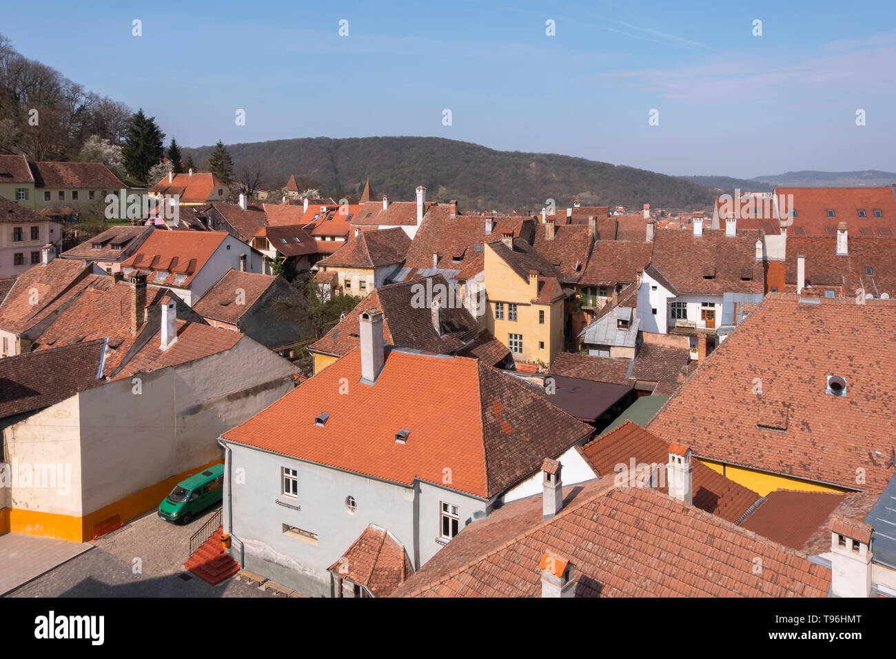 View from the Clock Tower in Sighisoara of colorful rooftops in the citadel on a day in spring. Stock Photo