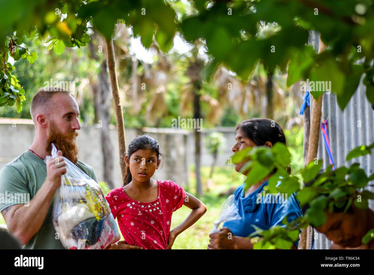 christian mission team giving aid to family in Guatemalan Stock Photo