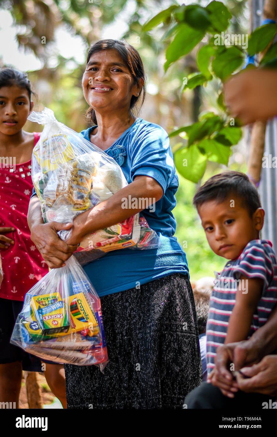 christian mission team giving aid to family in Guatemalan Stock Photo